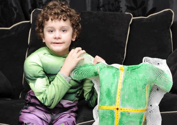 Callum Peers wore a special suit straight from the superhero's wardrobe to take on neuroblastoma. Pic: SWNS