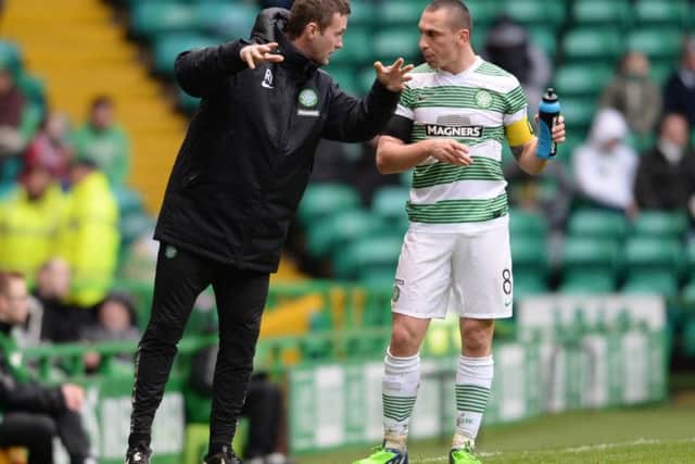 Celtic manager Ronny Deila passes on instructions to his captain Scott Brown on Sunday. Picture: SNS