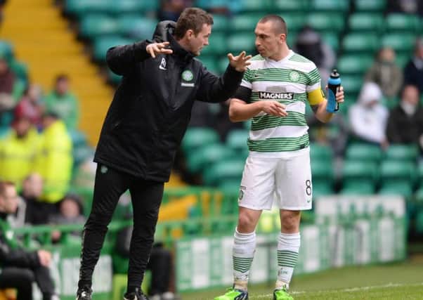 Celtic manager Ronny Deila passes on instructions to his captain Scott Brown on Sunday. Picture: SNS