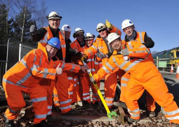 Keith Brown MSP helped clip the final length of track to the new Borders Railway. Picture: Stuart Cobley