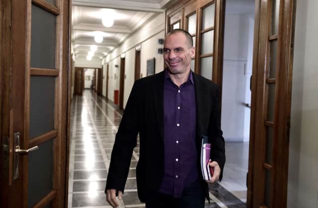 Greek finance minister Yanis Varoufakis beams as he arrives at parliament in Athens yesterday. Picture: Getty
