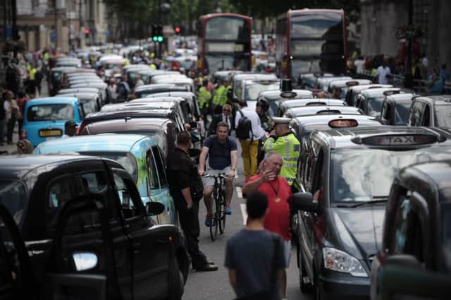 London cabbies stage a protest against Uber earlier this year by blocking traffic. Picture: Getty