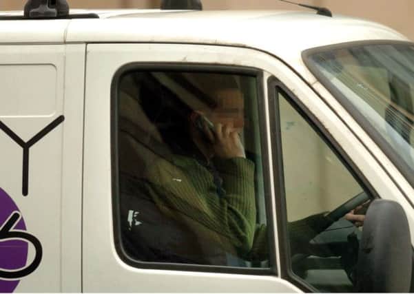 A van driver speaks on his mobile phone while driving. Picture: Ian Rutherford