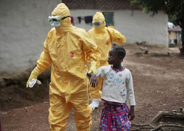 Medical workers treating Ebola victims wear protective clothing in Liberia. Picture: AP