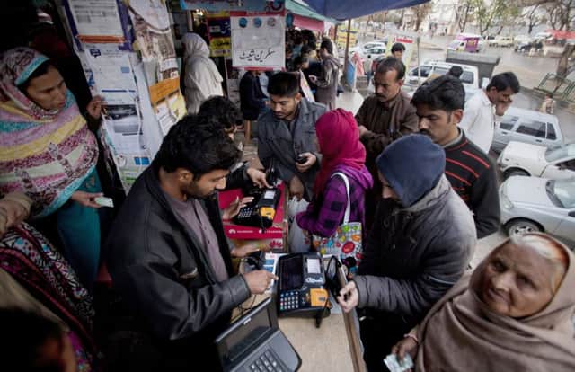 Pakistanis have been queuing up to verify their fingerprints to retain their mobiles. Picture: AP