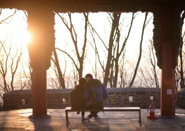 A couple embrace overlooking Seoul. Until now extramarital affairs were criminal offences. Picture: Getty