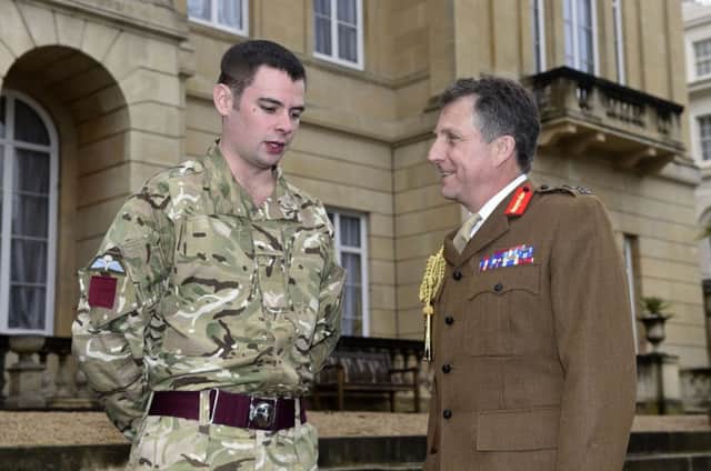 Lance Corporal Joshua Leakey speaks to the Sir Nicholas Carter. Picture: PA