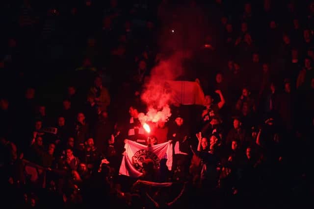 Celtic fans light a flare during the match. Picture: Getty