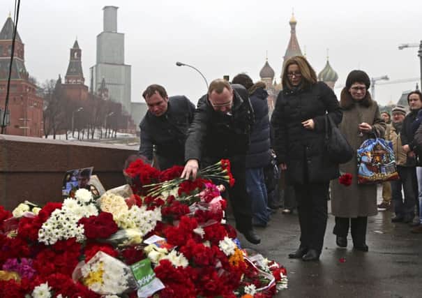 People lay flowers at the place where Boris Nemtsov was attacked at Red Square in Moscow. Picture: AP
