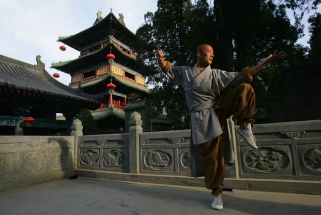 A warrior monk displays his martial arts skills at the Shaolin Temple in Dengfeng, Henan Province. Picture: Getty