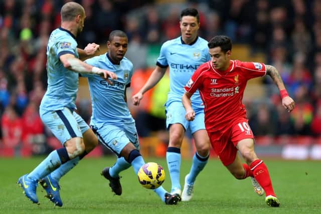 Liverpools Brazilian midfielder Philippe Coutinho tries to find a way through the Manchester City defence. Picture: Getty
