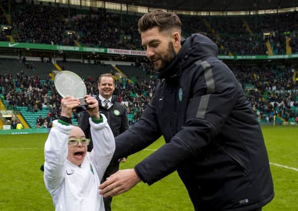 Delight for Celtic fan Jay Beattie as club defender Charlie Mulgrew hands him his SPFL Goal of the Month award. Picture: SNS
