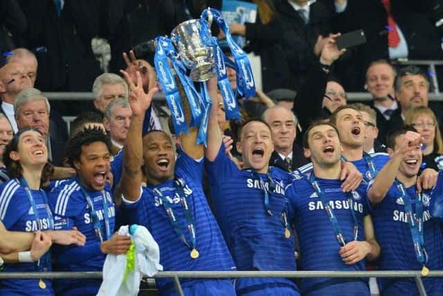 Chelsea striker Didier Drogba, third left, and captain John Terry lift the Capital One Cup. Picture: Getty