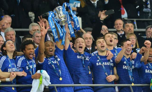 Chelsea striker Didier Drogba, third left, and captain John Terry lift the Capital One Cup. Picture: Getty