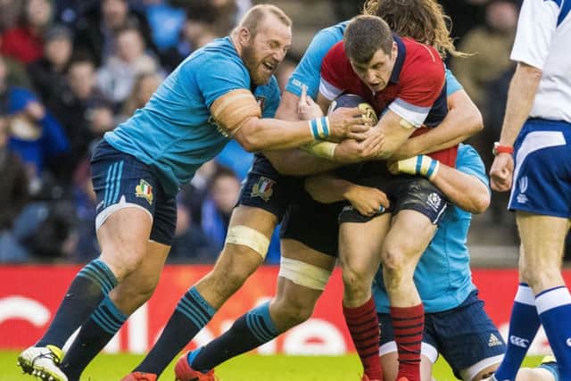 Mark Bennett (right) is tackled by Italy pair Dario Chistolini (left) and Joshua Furno. Picture: SNS