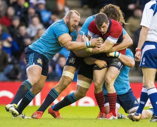 Mark Bennett (right) is tackled by Italy pair Dario Chistolini (left) and Joshua Furno. Picture: SNS