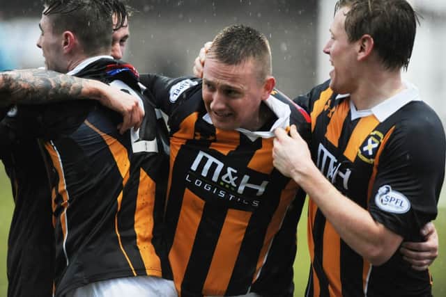 East Fife's players celebrate Derek Riordan's late winner.