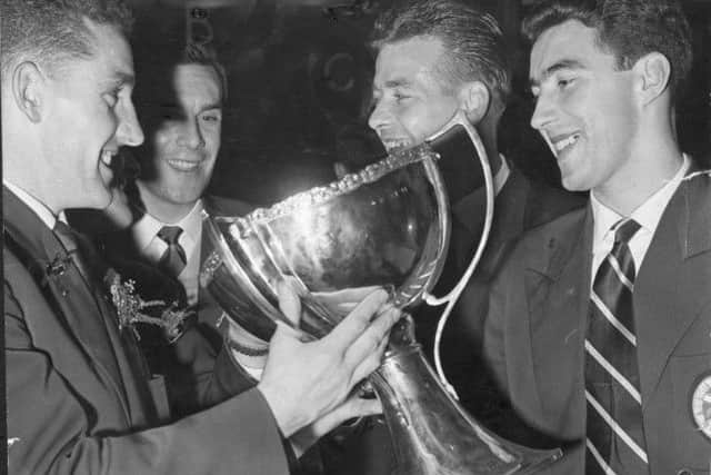 Dave MacKay, left, celebrates the League Cup victory with Hearts teammates in 1958. Picture: TSPL