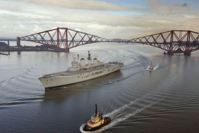 The aircraft carrier HMS Ark Royal makes her way under the Forth Rail Bridge in February 2004. Picture: Getty