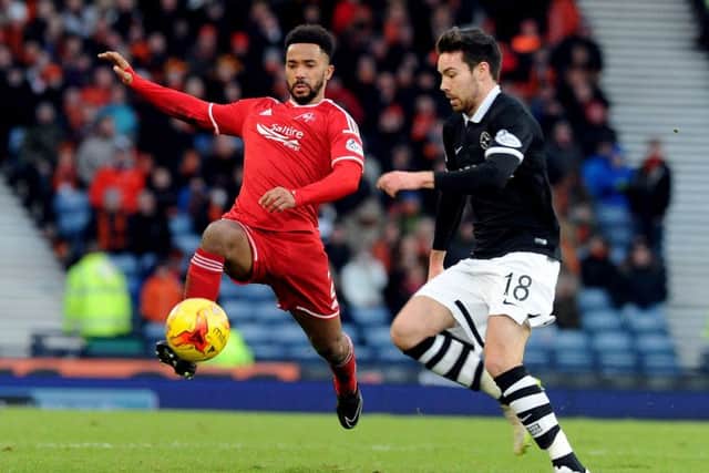 Police are investigating an offensive tweet allegedly addressed to Aberdeen player Shay Logan, left. Picture: Lisa Ferguson