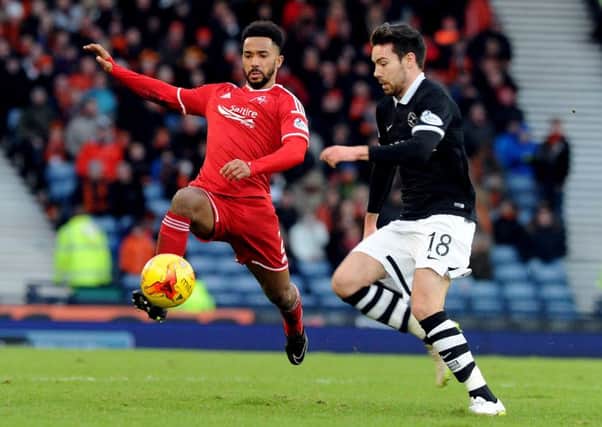 Police are investigating an offensive tweet allegedly addressed to Aberdeen player Shay Logan, left. Picture: Lisa Ferguson