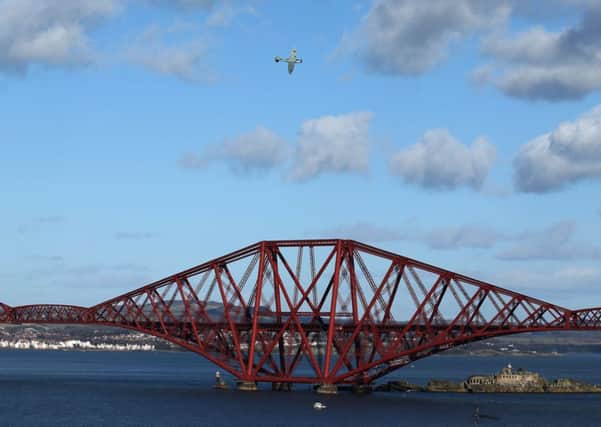 A flypast by a replica Spitfire marks the 125th anniversary of the Forth Bridge. Picture: PA