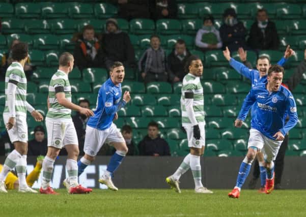 Celtic players look stunned as Danny Swanson wheels away to celebrate his goal. Picture: SNS