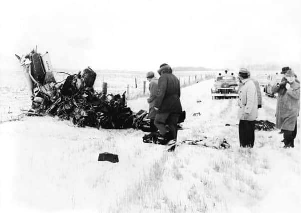 A group of men view the wreckage of the light aircraft. Picture: Getty
