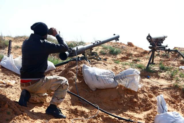 A fighter from an alliance of Islamist-backed militias, take position near Tripoli yesterday. Picture: AFP