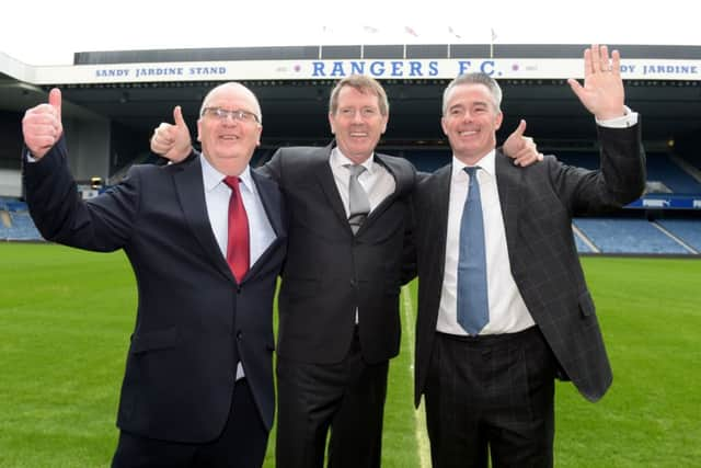 Dave King, centre, celebrates success at the club's EGM alongside John Gilligan, left, and Paul Murray. Picture: SNS