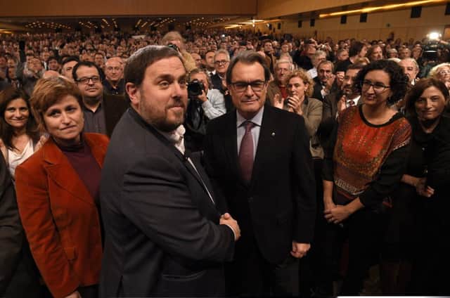 Oriol Junqueras, left, shakes hands with Artur Mas. Picture: Getty