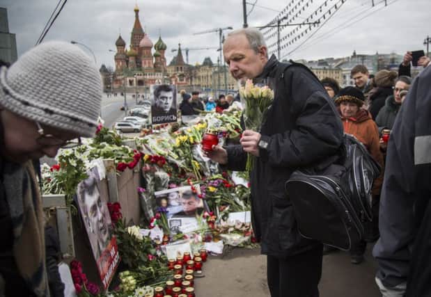 Mourners lay flowers at the site near the Kremlin where Boris Nemtsov was killed. Picture: AP