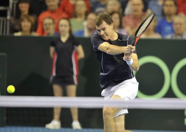 Jamie Murray drives a forehand during a thrilling match. Picture: Ian Rutherford