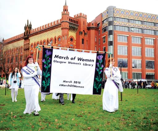 Women dressed as suffragettes march at Glasgow Green to commemorate the struggle. Picture: John Devlin
