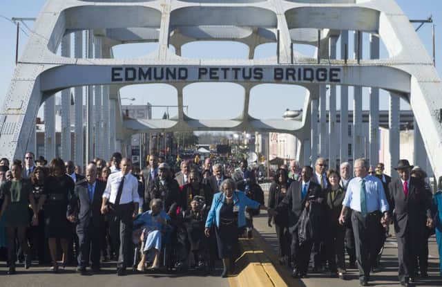 A jacketless Barack Obama is joined on the bridge by his similarly attired predecessor, George W Bush. Picture: Getty