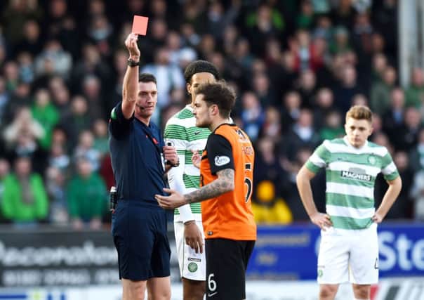 Referee Craig Thomson (left) sends off Dundee Utd's Paul Paton. Picture: SNS