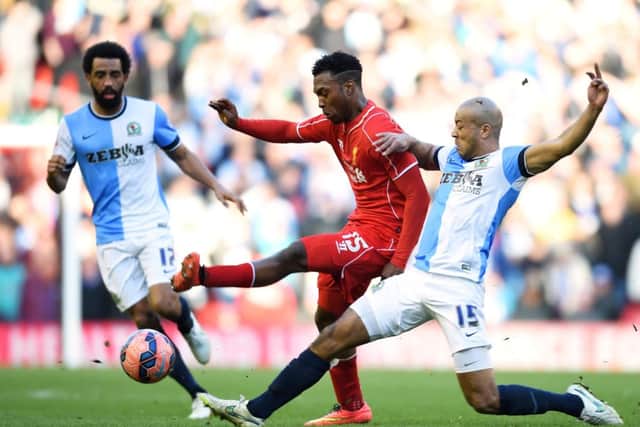 Liverpool striker Daniel Sturridge is tackled by Alex Baptiste of Blackburn. Picture: Getty