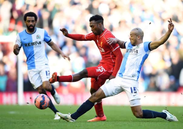 Liverpool striker Daniel Sturridge is tackled by Alex Baptiste of Blackburn. Picture: Getty