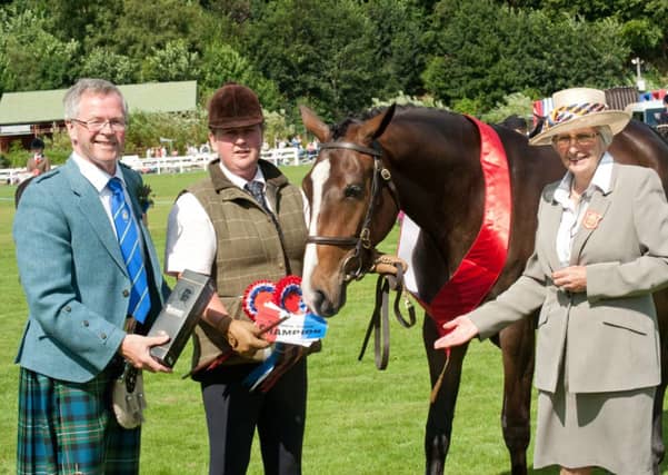 Farmer Bruce Ferguson presenting a prize to Lorna Gilbert at Turriff Show. Picture: Newsline Media