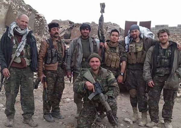 Kurdish fighters and foreign volunteers fighting Islanmic State pose for a photo in Sinjar, Iraq. Australian Ashley 'Ase' Johnson, right, and Konstandinos Erik Scurfield, front, have died. Picture: AP