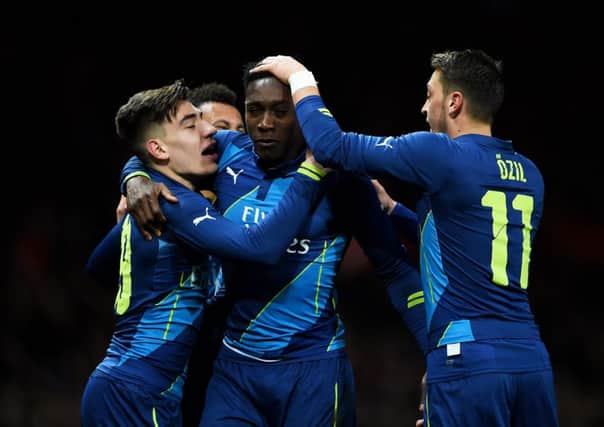 Danny Welbeck is mobbed by Arsenal team-mates after scoring his side's second goal. Picture: Getty