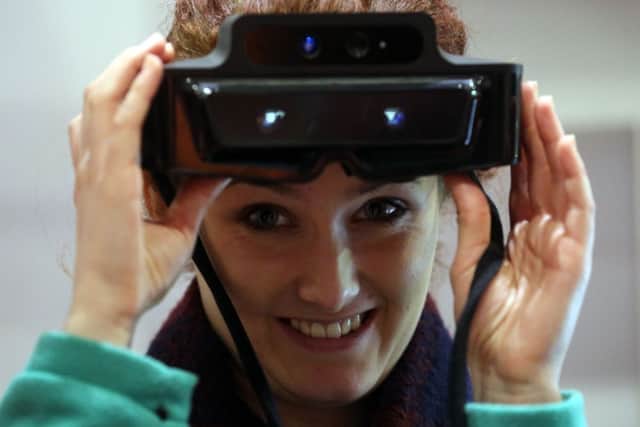 Lauren Hurley tries out the augmented reality Meta 1 reality kit headset. Picture: PA