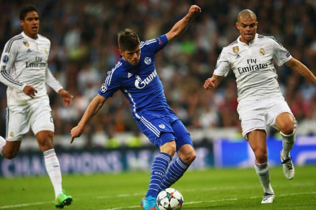 Klaas Jan Huntelaar of Schalke beats Pepe of Real Madrid to score their fourth goal - but it still wasn't enough to see them past the Spanish side. Picture: Getty
