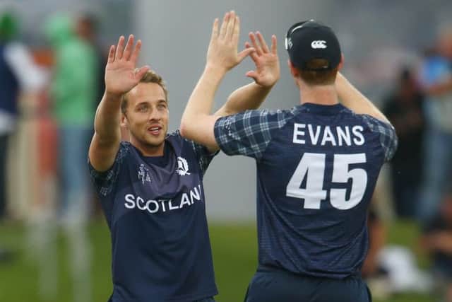 Josh Davey of Scotland celebrates with Alasdair Evans of Scotland after taking the wicket of Kumar Sangakkara. Picture: Getty