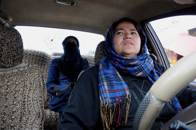 Sara Bahai behind the wheel of her cab in Mazar-i-Sharif. Picture: AP