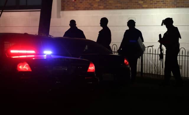 Police gather outside the Ferguson Police Department following the shooting. Picture: AP