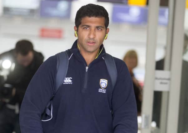 Majid Haq arrives back at Glasgow airport yesterday. Picture: Jeff Holmes