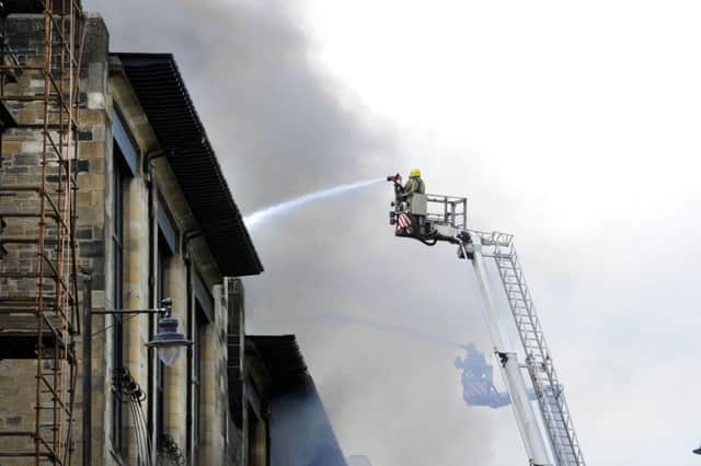 Firefighters trying to put out the blaze in May last year. Picture: John Devlin