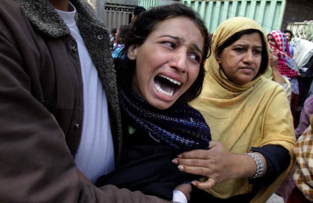 A woman mourns over a family member who was killed in Lahore. Picture: AP