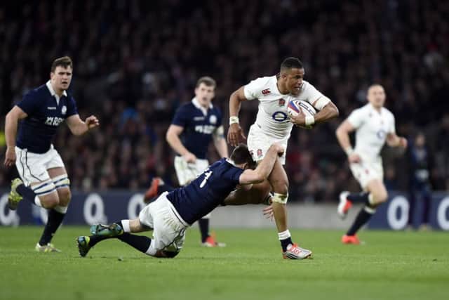 England's Anthony Watson gets away from a tackle by Tommy Seymour. Picture: PA